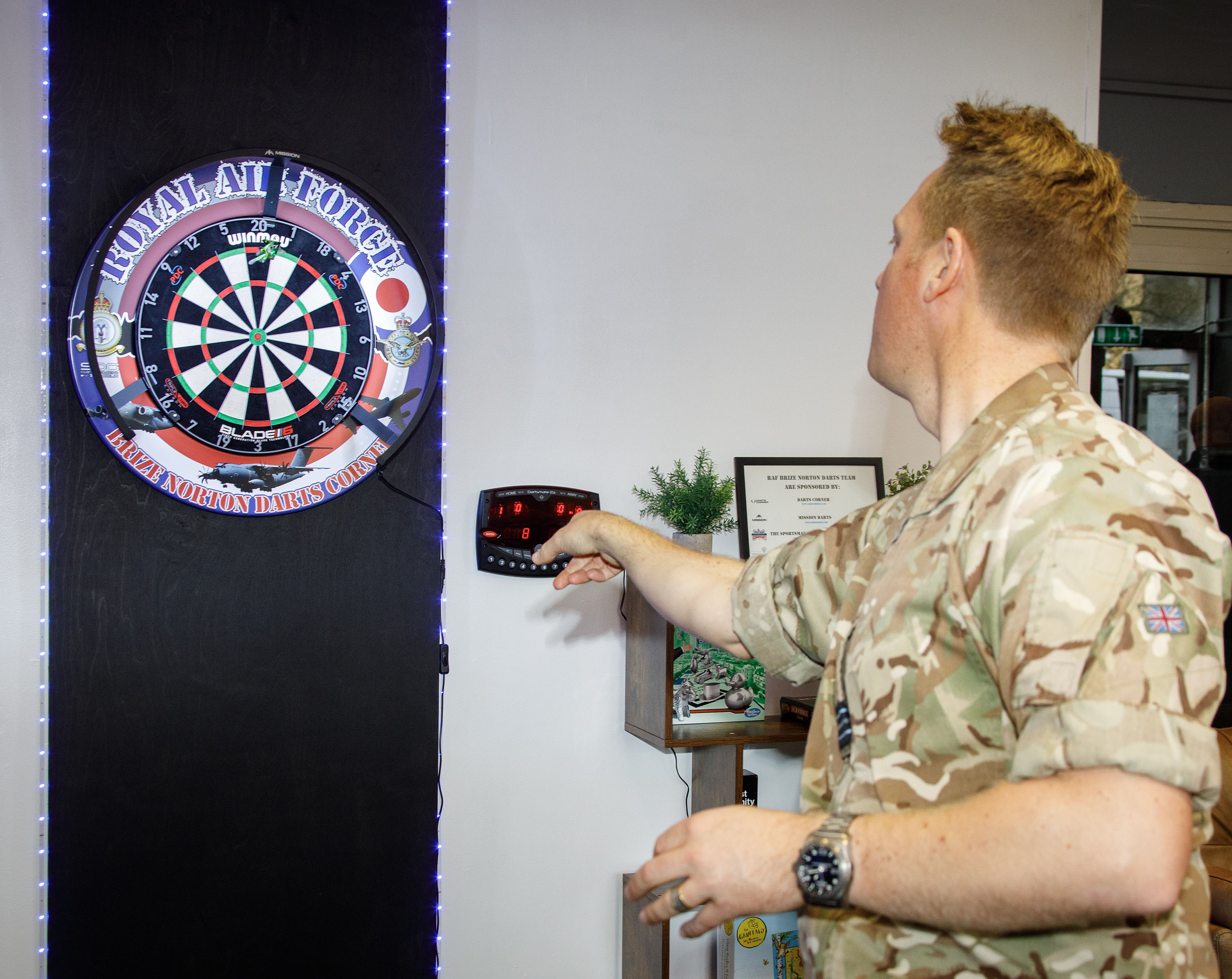 Photo - RAF Brize Norton Darts Team member throwing a dart at dartboard